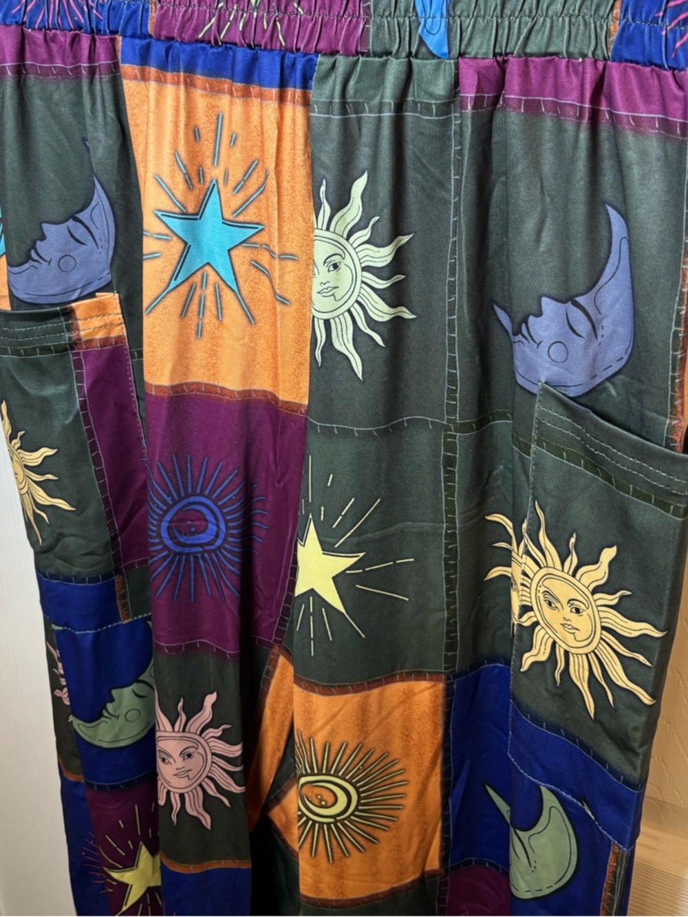 Multicoloured patchwork pants with sun and moon designs. Size: M